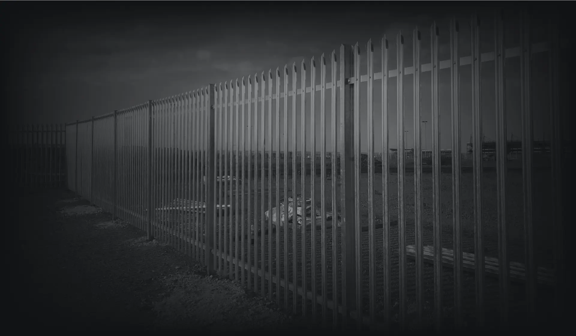 A tall white security fence